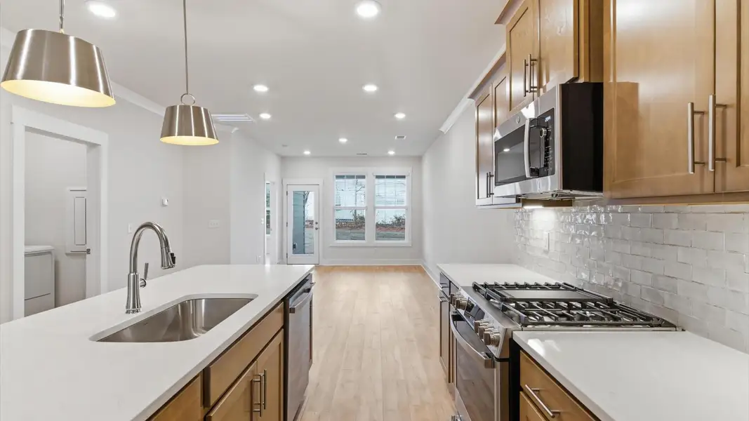 Accomplished kitchen design featuring pendant lighting above a statement island for both prep and gathering in Greenville, SC