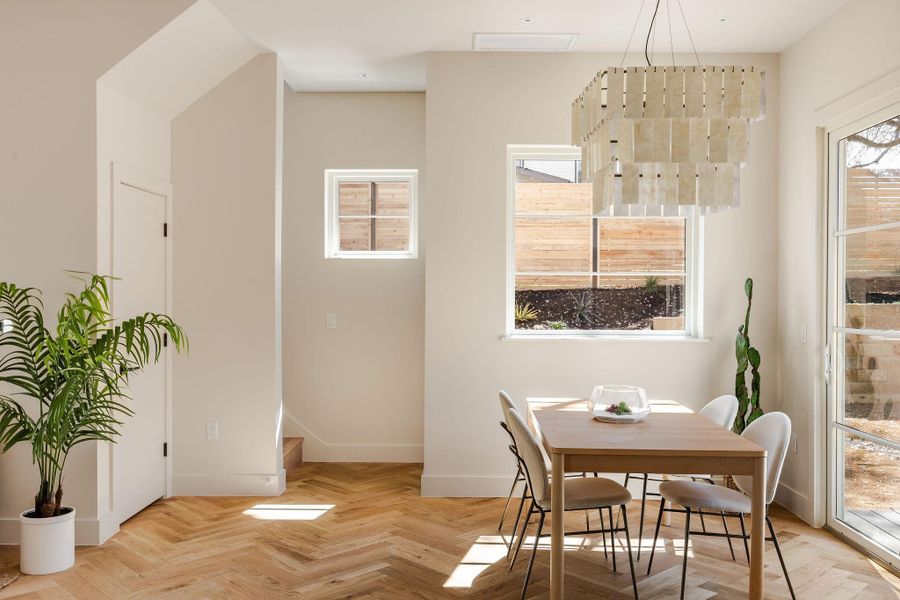 Dining area with stairs to second and third floors.