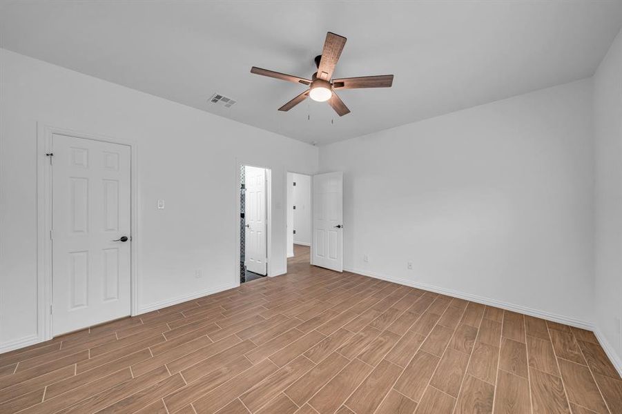 Unfurnished bedroom with ceiling fan and light hardwood / wood-style flooring