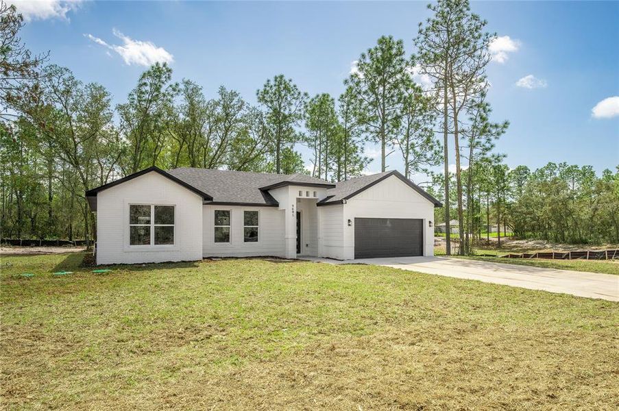 Front exterior of a new home in , Citrus Springs, FL, highlighting curb appeal (Image 1). Front exterior of a new home in , Citrus Springs, FL, highlighting curb appeal (Image 1).