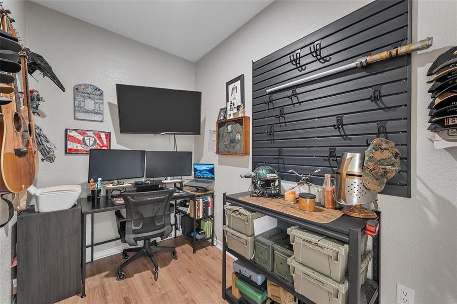 Office featuring a textured wall and light wood-style floors