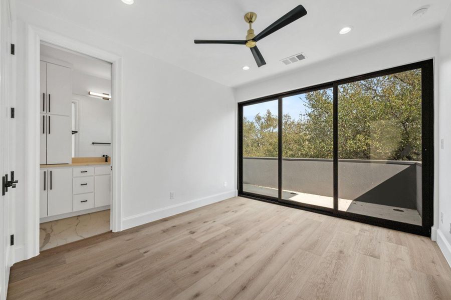 Unfurnished bedroom with light wood-style flooring, ceiling fan, access to outside, recessed lighting, and connected bathroom