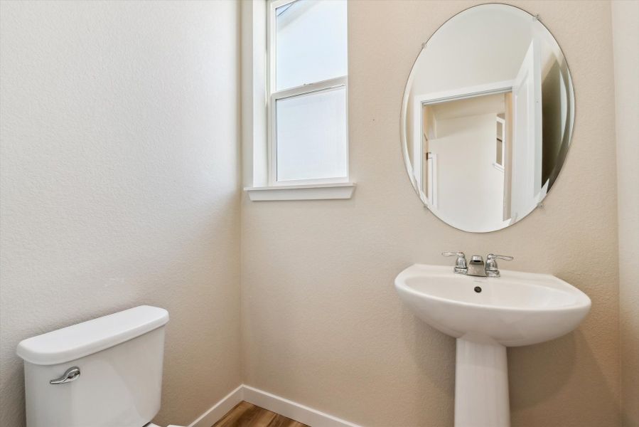 A bathroom with a mirror and sink.