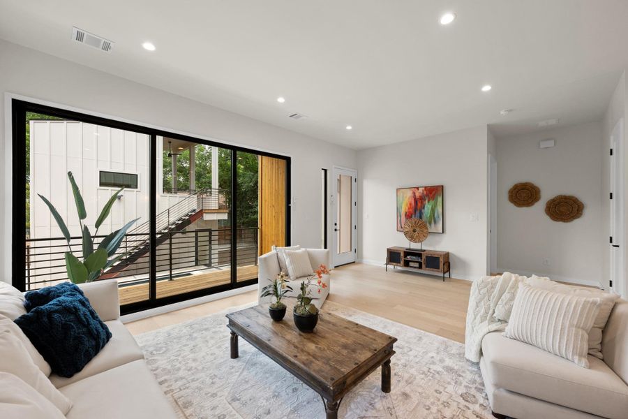 Floor-to-ceiling glass panels connect the inviting living area with a private outdoor space. Floor-to-ceiling glass panels connect the inviting living area with a private outdoor space.