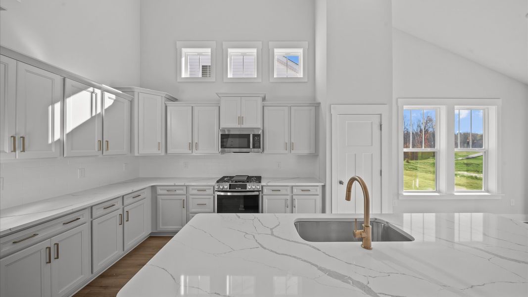 Well-designed kitchen with a center island and tasteful finishes that elevate everyday living