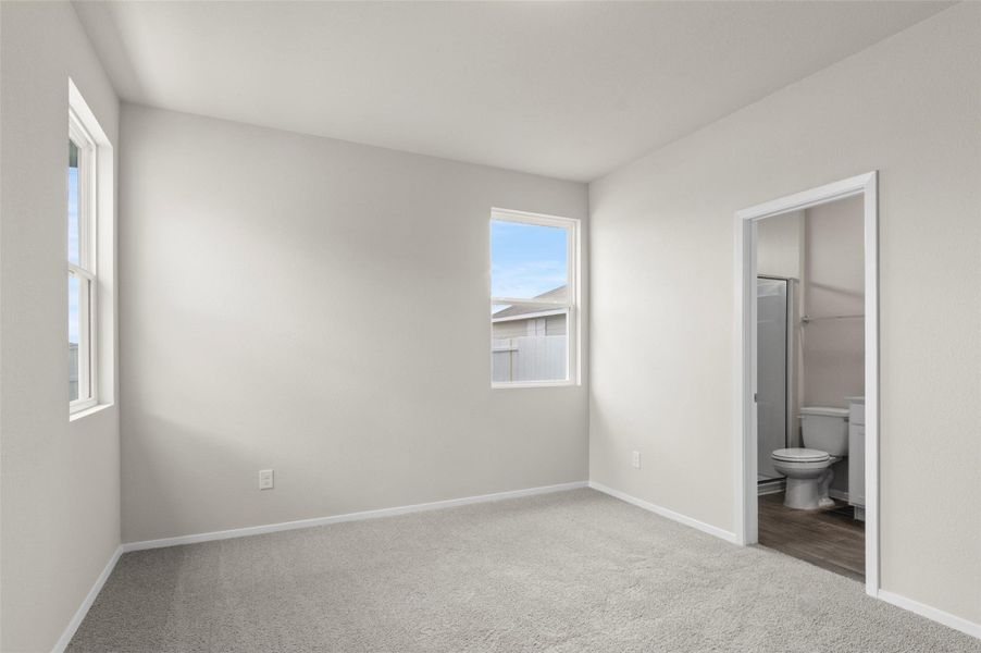 Unfurnished bedroom with carpet and ensuite bathroom