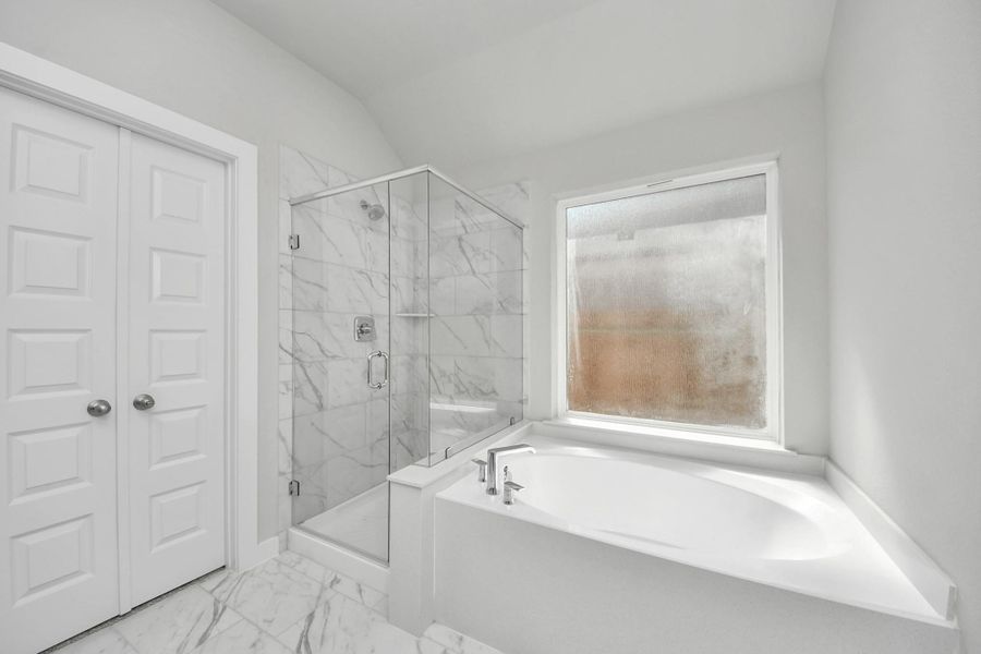 Indulge in a spa-like retreat within the confines of this primary bathroom. Sample photo of completed home with similar floor plan. Actual colors and selections may vary. Indulge in a spa-like retreat within the confines of this primary bathroom. Sample photo of completed home with similar floor plan. Actual colors and selections may vary.