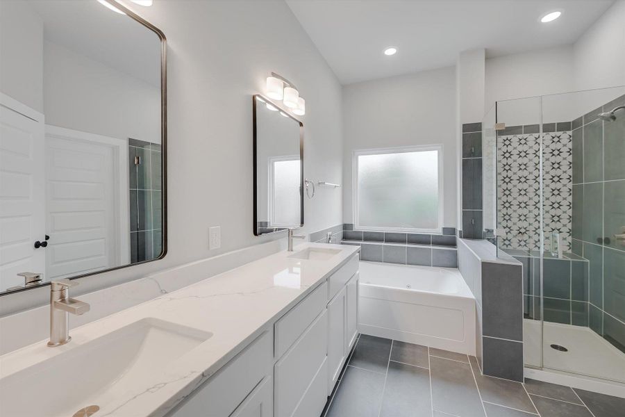 Full bathroom featuring tile patterned flooring, a sink, and a shower stall