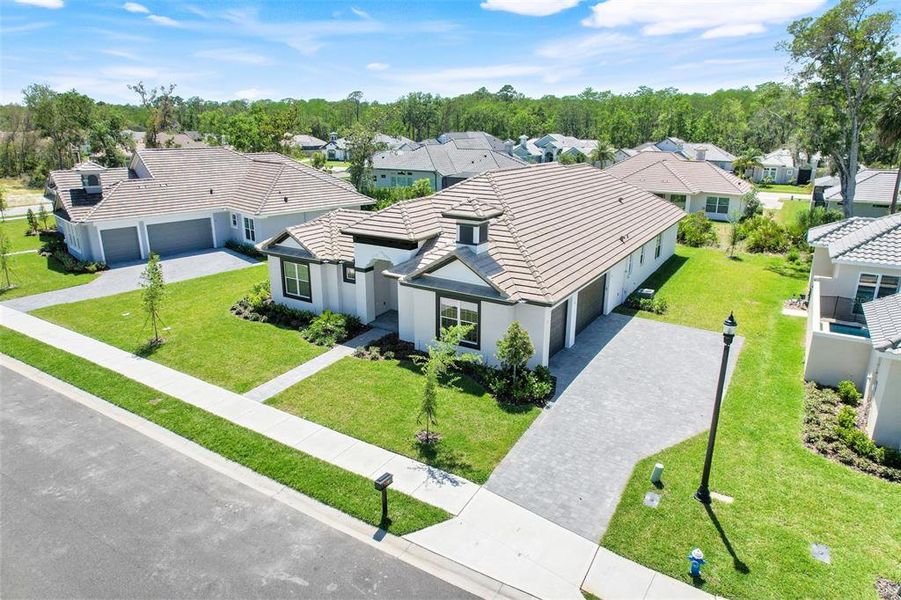 Front exterior of a new home in Toscana, Palm Coast, FL, highlighting curb appeal (Image 21).