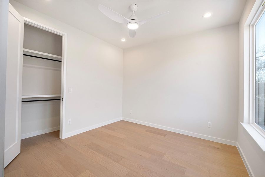 Unfurnished bedroom with recessed lighting, a ceiling fan, light wood finished floors, and a closet
