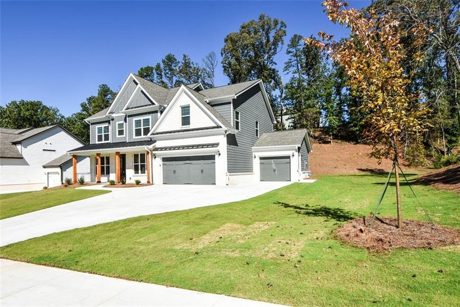 Front exterior of a new home in , Cumming, GA, highlighting curb appeal (Image 1). Front exterior of a new home in , Cumming, GA, highlighting curb appeal (Image 1).