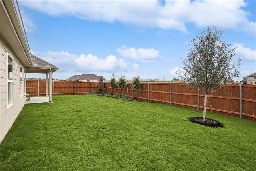 Fenced backyard featuring a patio