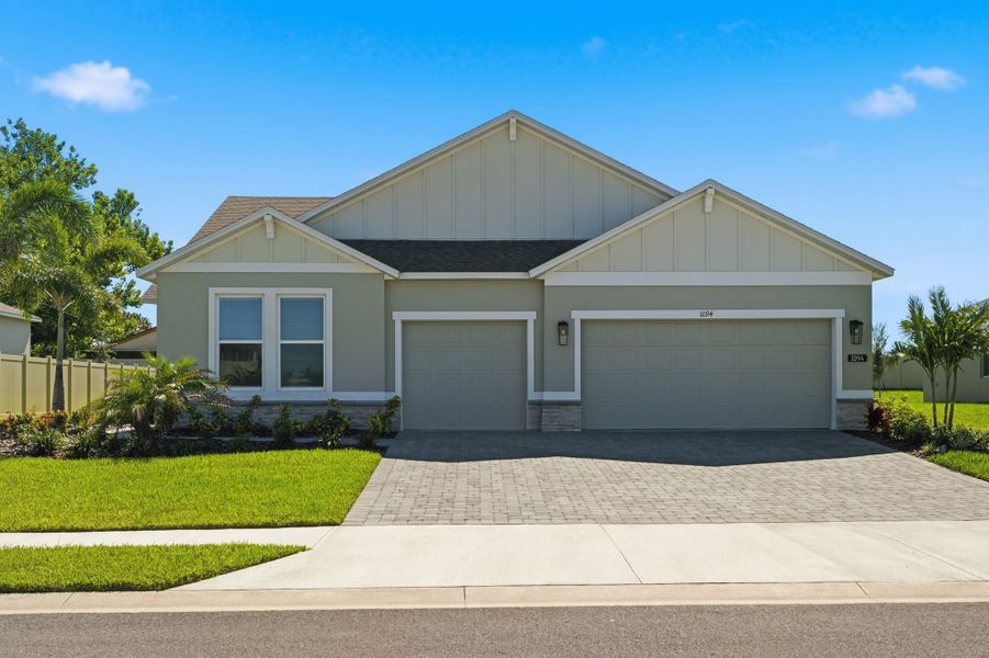 Front exterior of a new home in Country Club Estates, Palm Bay, FL, highlighting curb appeal (Image 1). Front exterior of a new home in Country Club Estates, Palm Bay, FL, highlighting curb appeal (Image 1).