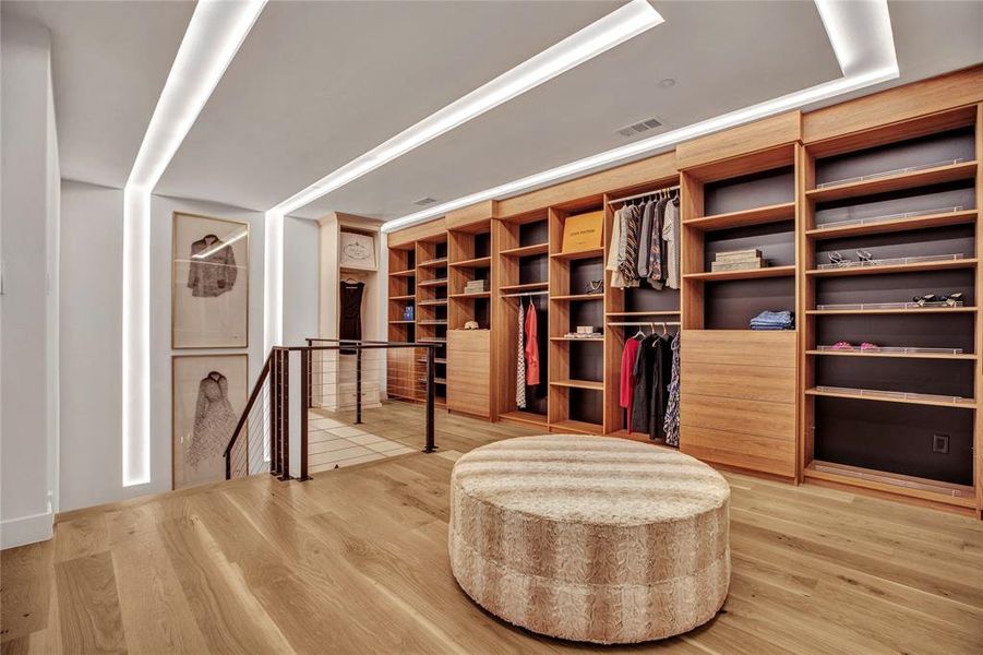 Walk in closet featuring light wood-type flooring Walk in closet featuring light wood-type flooring