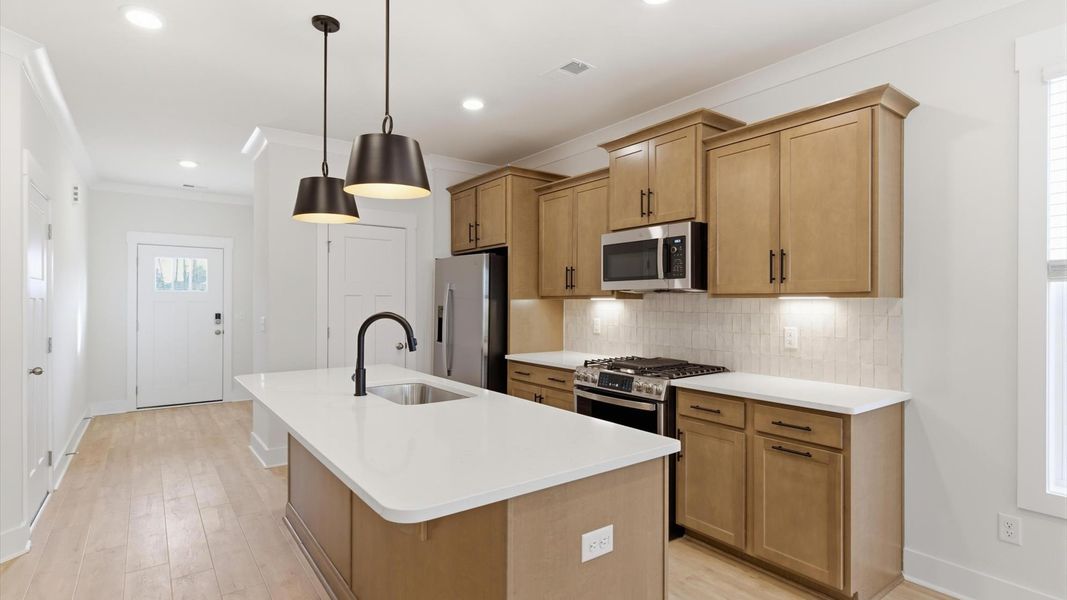 Exclusive kitchen design with large island, pendant lights, and tasteful finishes throughout