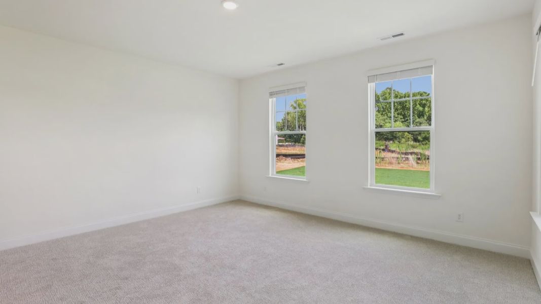 Pendleton home plan spacious first floor primary bedroom/suite with windows and attached bath