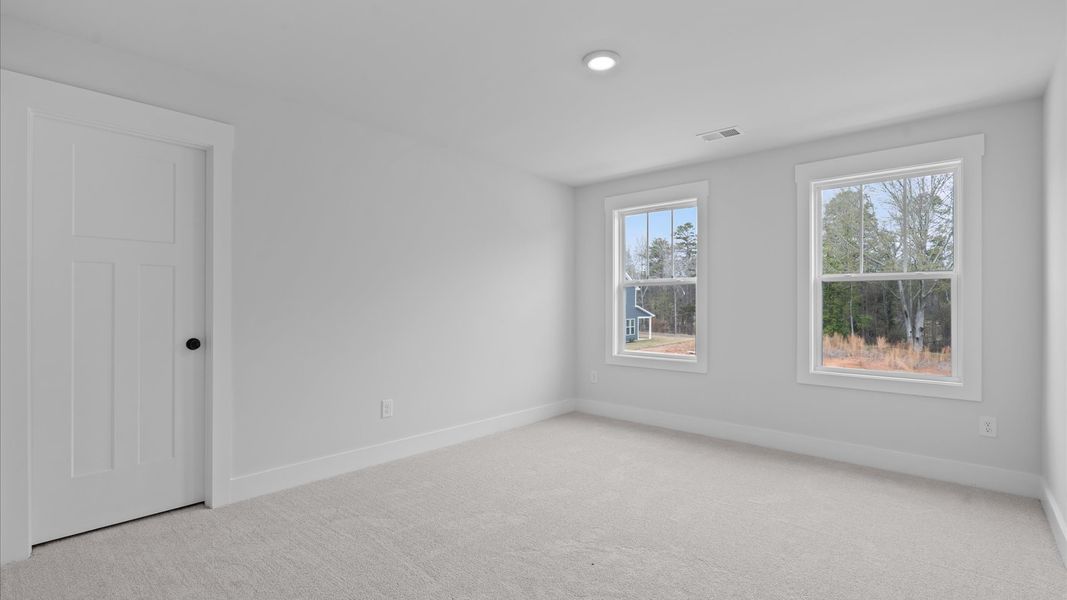 First-class bedroom with generous proportions, a walk-in closet, and beautiful natural light through large windows