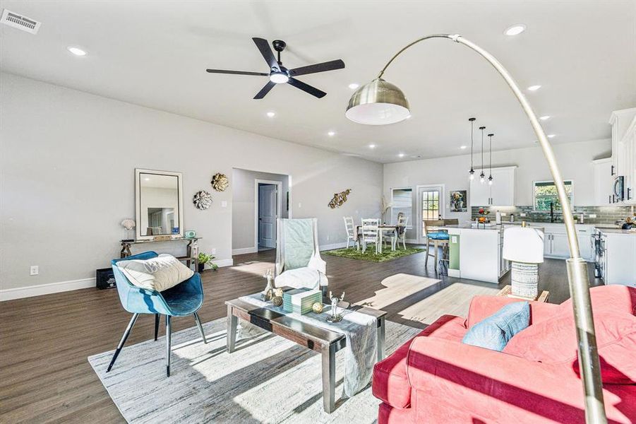 Living room featuring recessed lighting, ceiling fan, and wood finished floors