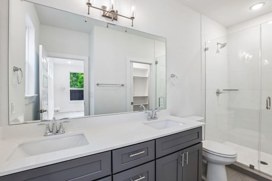 The primary ensuite features a dualquartz vanity.