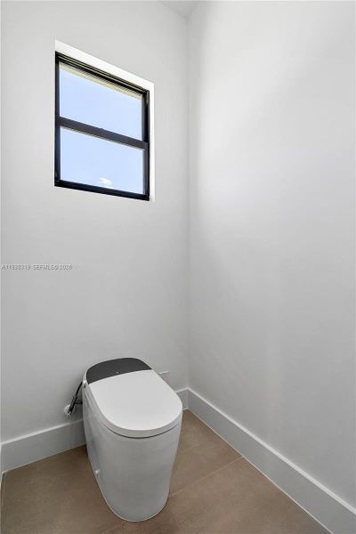 The primary bathroom is equipped with an electric toilet featuring integrated bidet functions for added comfort and convenience.