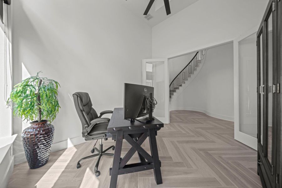 Glass French doors open to a private office with high ceilings and flexible use. A perfect balance of openness and focus. Glass French doors open to a private office with high ceilings and flexible use. A perfect balance of openness and focus.