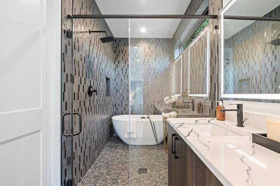Bathroom with tile walls, a soaking tub, vanity, a shower stall, and granite tiled floors