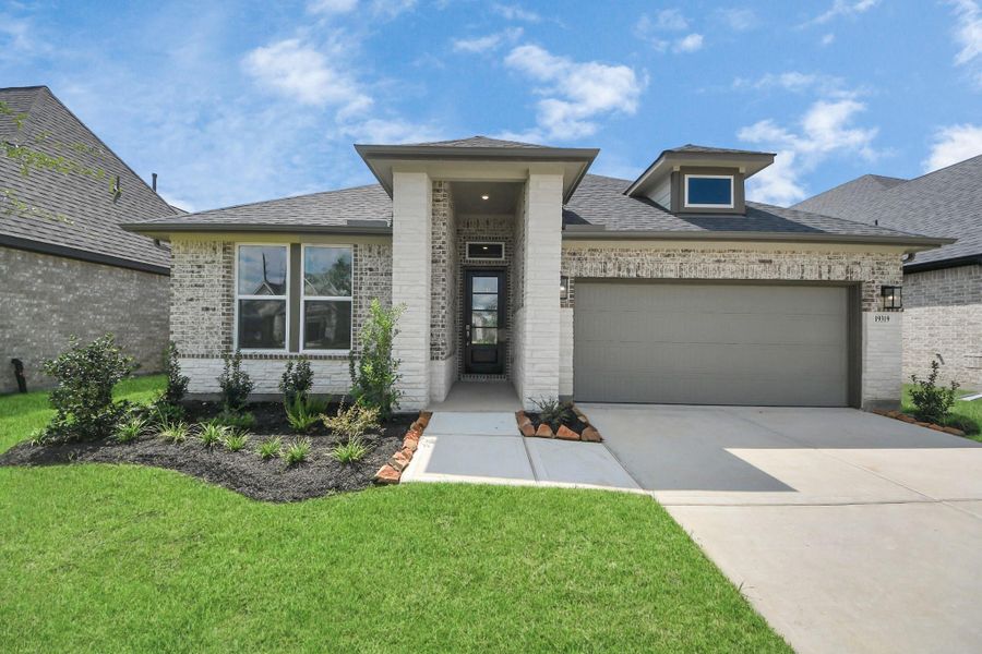 Front exterior of a new home in Amira: Heritage Collection, Tomball, TX, highlighting curb appeal (Image 16). Front exterior of a new home in Amira: Heritage Collection, Tomball, TX, highlighting curb appeal (Image 16).