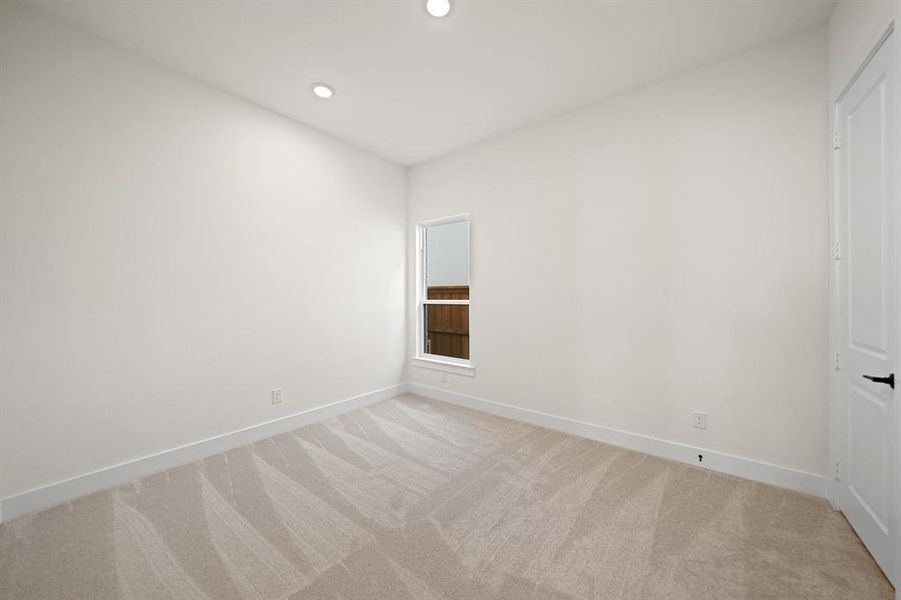 Empty room with light carpet and recessed lighting Empty room with light carpet and recessed lighting