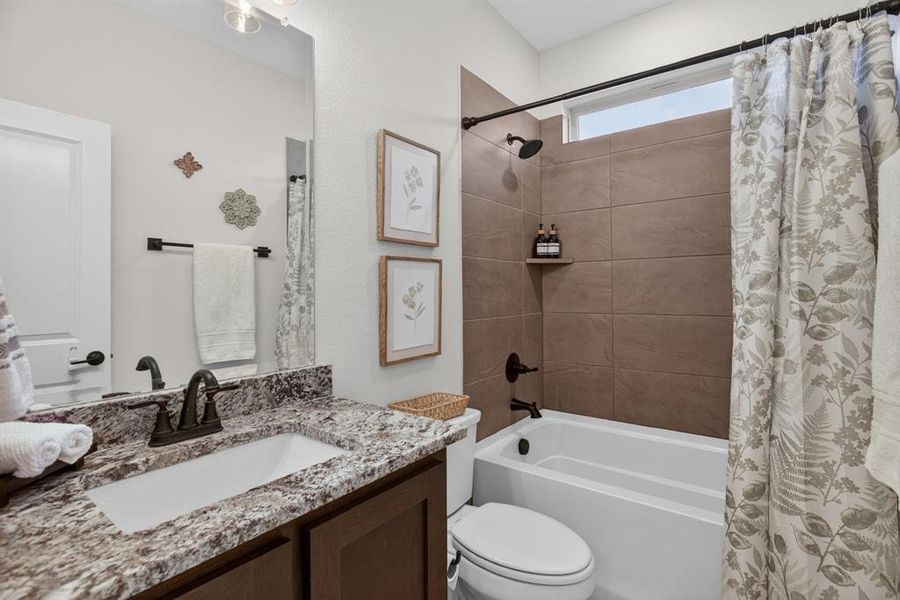 Downstairs guest bathroom with tiled tub-shower combo, nice fixtures and pretty countertops. Bloomfield always has nice details! Downstairs guest bathroom with tiled tub-shower combo, nice fixtures and pretty countertops. Bloomfield always has nice details!