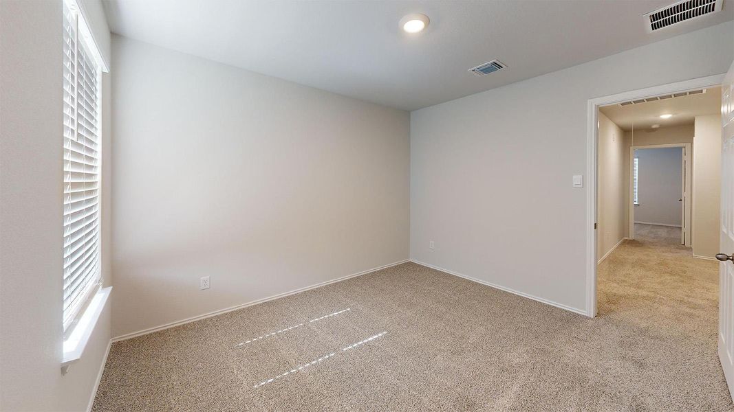 Unfurnished room with light colored carpet, healthy amount of natural light, and recessed lighting