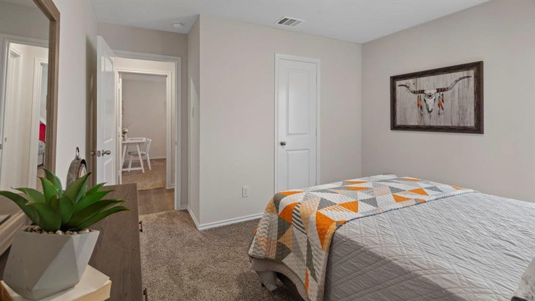 Carpeted bedroom with baseboards