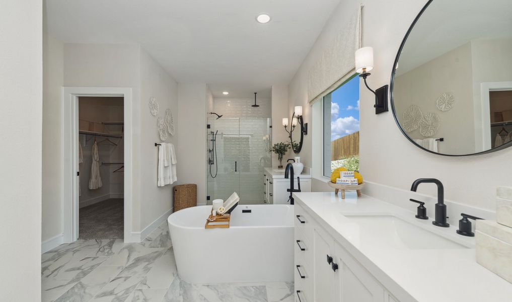 Freestanding bath tub with matte black fixtures