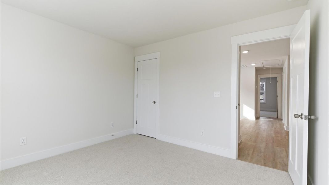 Refined bedroom design with large windows for daylight-filled mornings and peaceful views