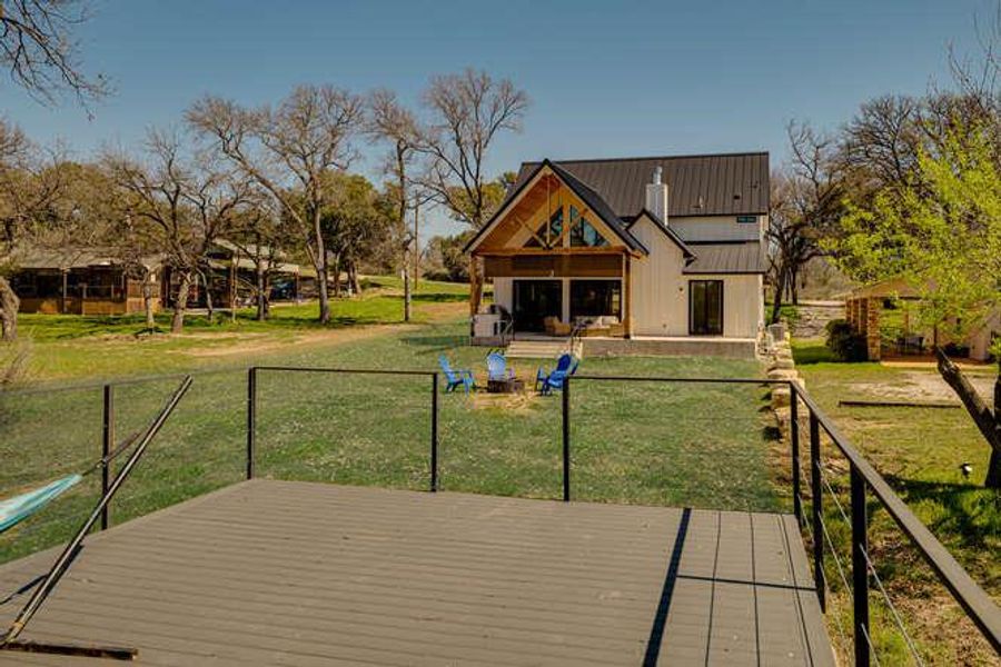 Wooden deck featuring a patio area and a lawn