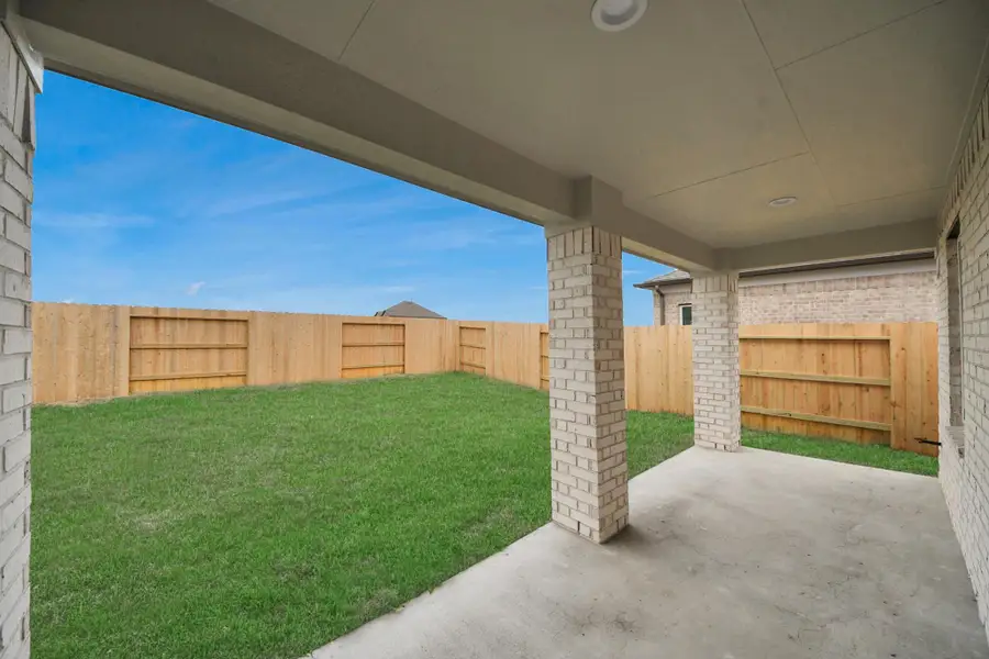Experience outdoor living at its finest on this expansive covered patio, thoughtfully designed for BBQs and delightful outdoor dining.