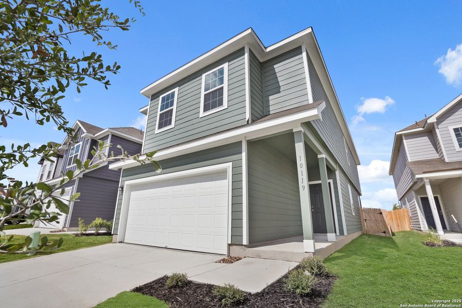 Front exterior of a new home in Melissa Ranch, San Antonio, TX, highlighting curb appeal (Image 17). Front exterior of a new home in Melissa Ranch, San Antonio, TX, highlighting curb appeal (Image 17).