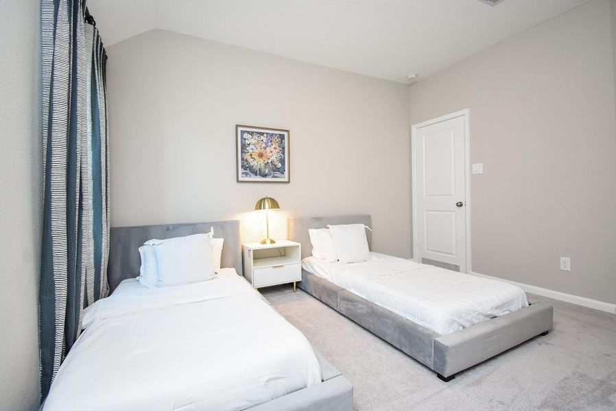 A bright and inviting bedroom with plenty of room for relaxation and storage.