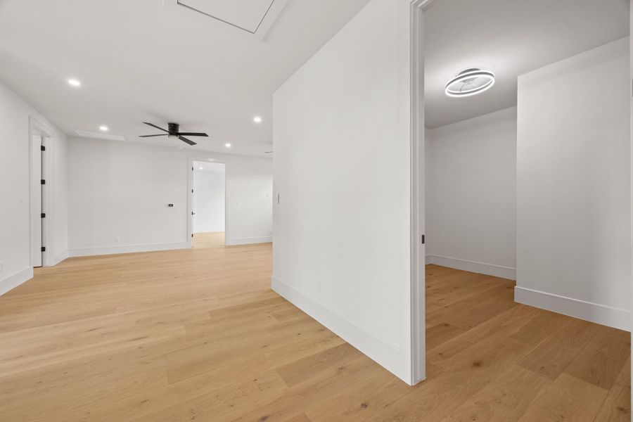 Smooth plaster walls meet warm hardwood floors across a flowing, modern layout.