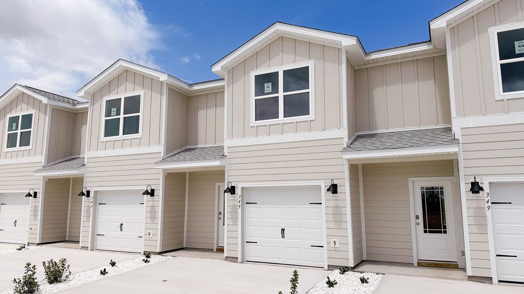 Front exterior of a new home in WindMark Beach, Port Saint Joe, FL, highlighting curb appeal (Image 19).