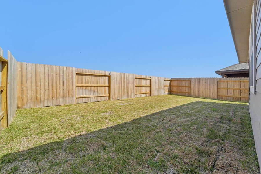 Exterior details and patio area of a home in Landing Meadows - Traditional Series, New Caney (Image 22).