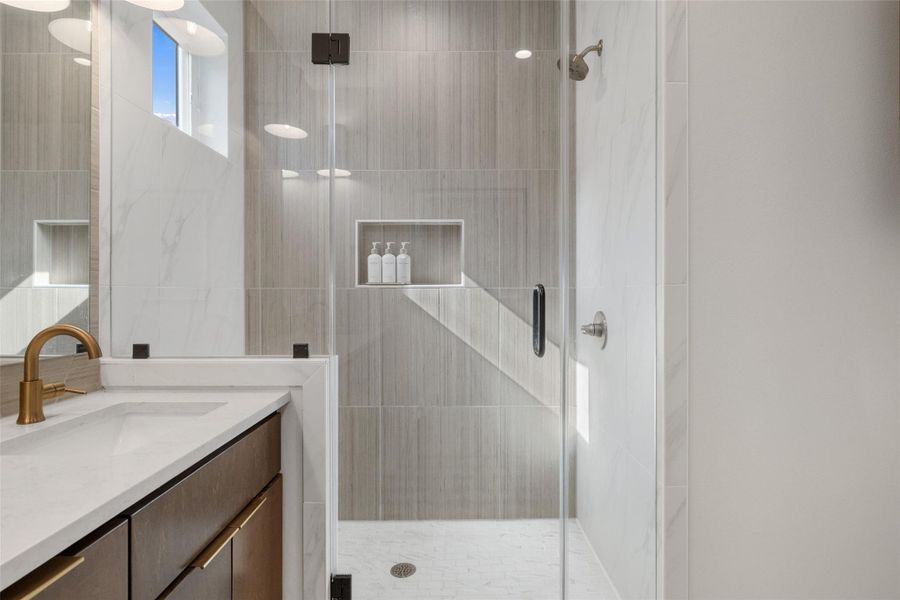 Bathroom with vanity and a shower stall