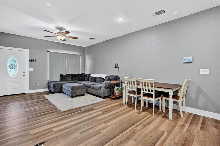 Living room featuring a ceiling fan, wood finished floors, and recessed lighting Living room featuring a ceiling fan, wood finished floors, and recessed lighting
