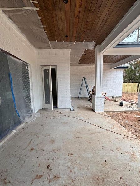 Oversized back porch with tounge & groove ceilings.