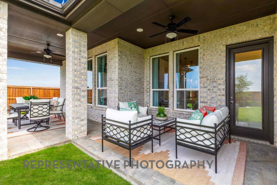 View of patio featuring an outdoor hangout area, fence, outdoor dining area, and a ceiling fan View of patio featuring an outdoor hangout area, fence, outdoor dining area, and a ceiling fan