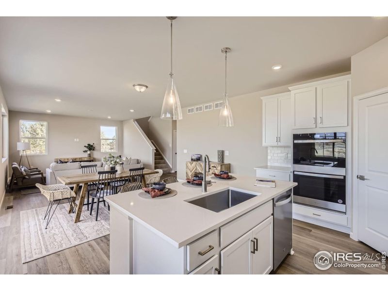 Kitchen to great room *Photo not of actual home, but same floorplan and style*