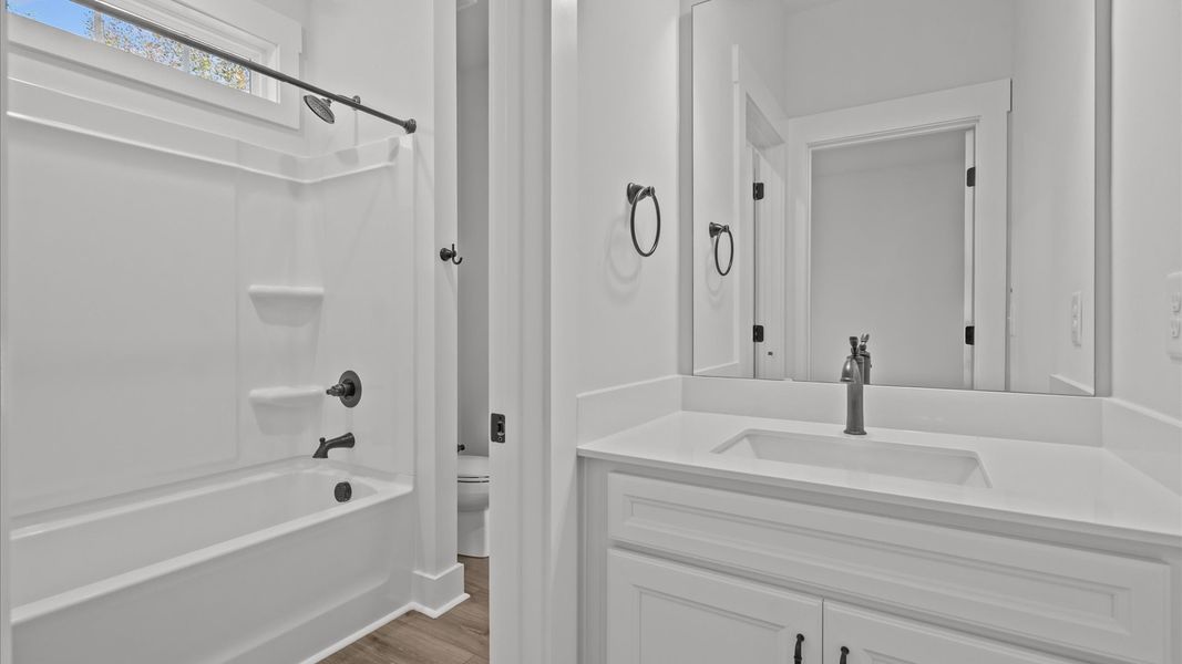 Accomplished bathroom design with sleek tile, high-quality cabinetry, and refined hardware