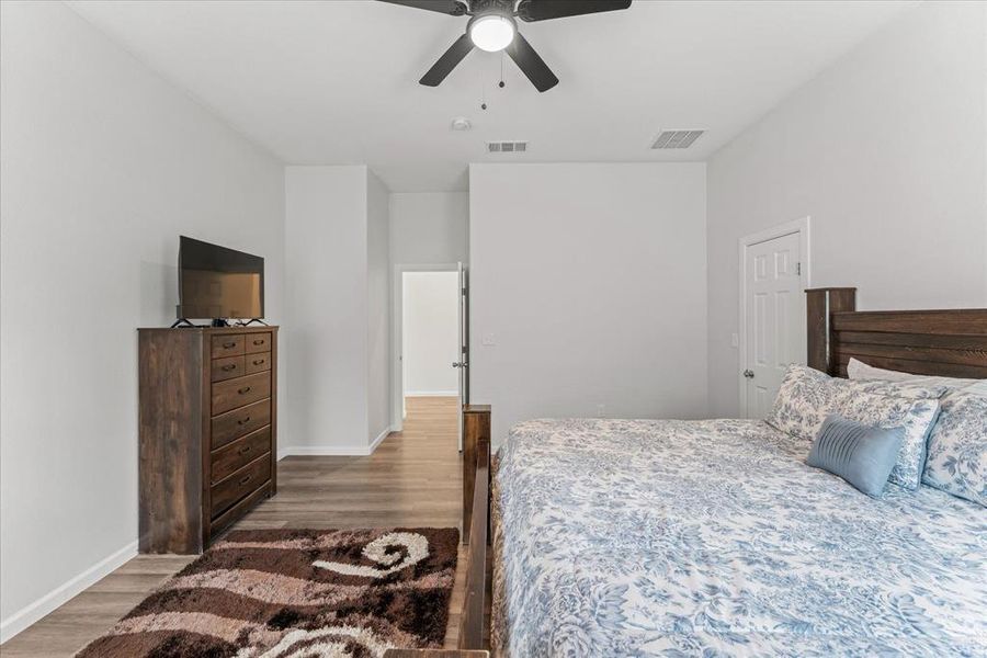 Bedroom with wood finished floors and a ceiling fan