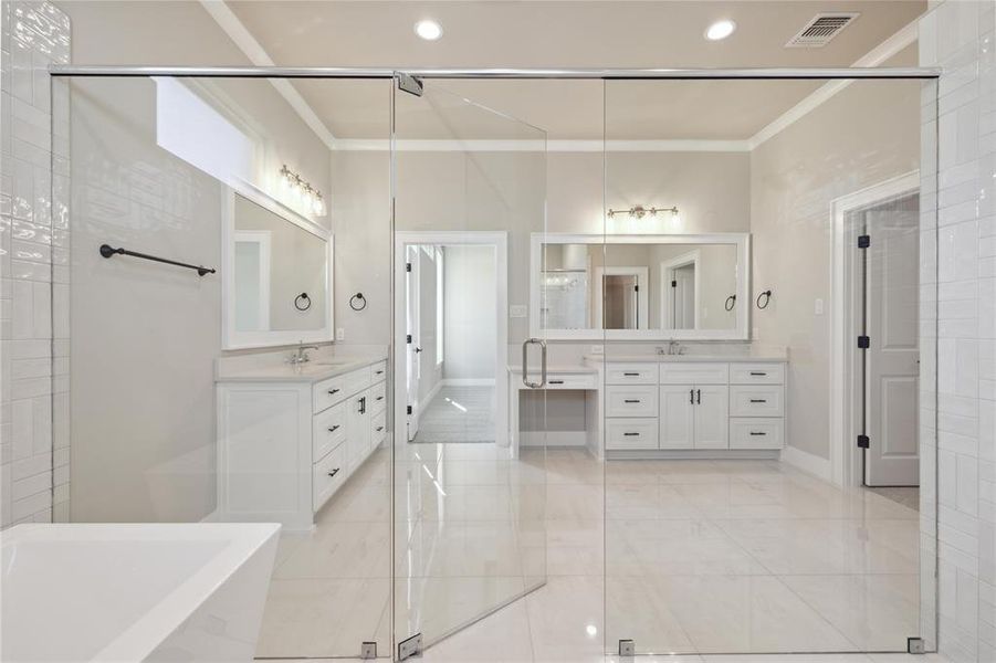 Bathroom with ornamental molding, vanity, and plus walk in shower