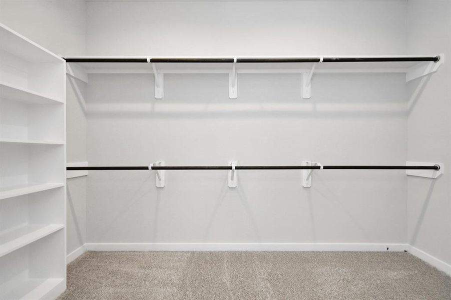 Massive walk in closet with plenty of hanging and storage space.