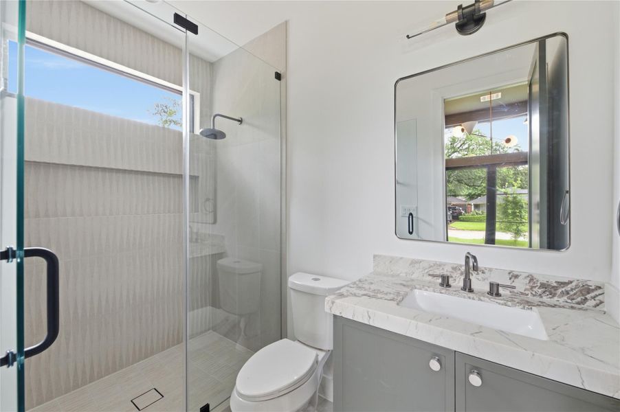Conveniently located off the main living area, this stylish full guest bath offers both comfort and privacy for visitors.